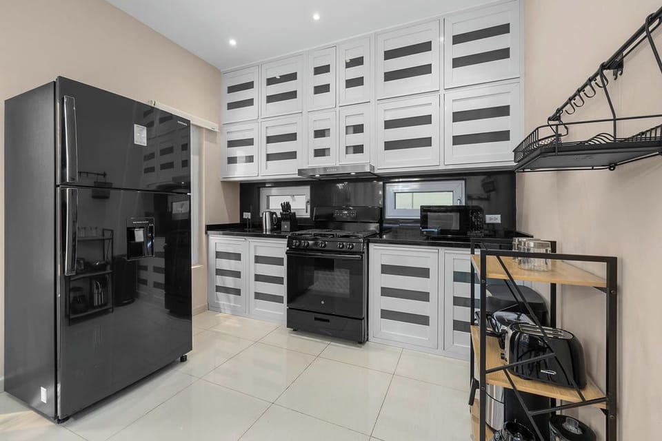 Cook with ease in the spacious kitchen, fully equipped with modern appliances, cookware, and all the essentials for preparing delicious meals during your stay.