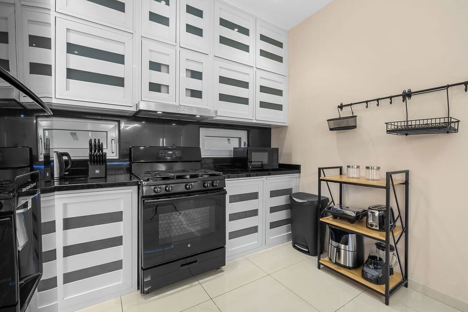 Cook with ease in the spacious kitchen, fully equipped with modern appliances, cookware, and all the essentials for preparing delicious meals during your stay.