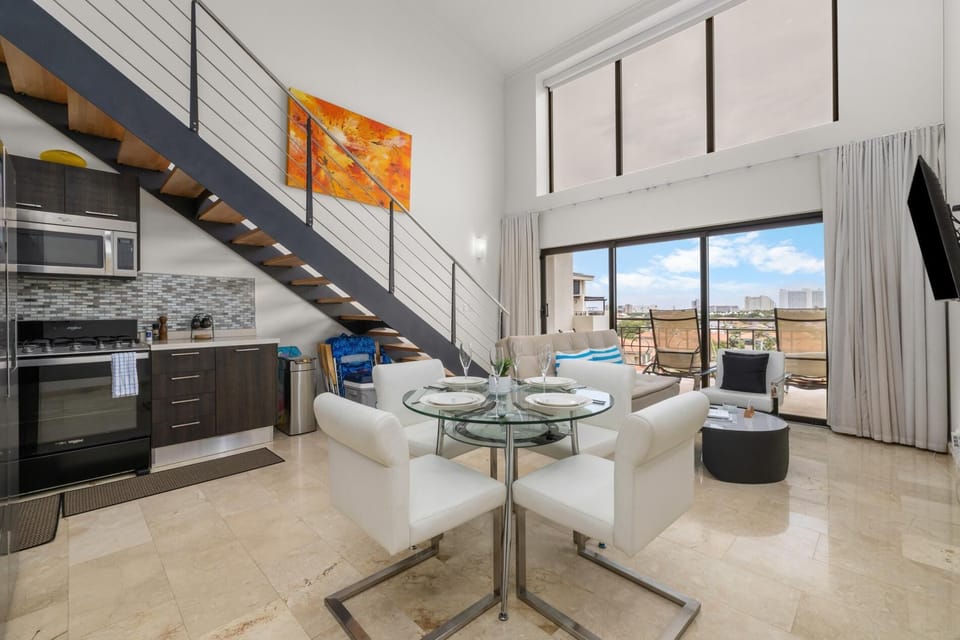 Dine with a view! Host a memorable dinner at our sleek glass table, then step out onto the balcony for city lights. With a fully equipped, modern kitchen right there, preparing meals is a breeze.