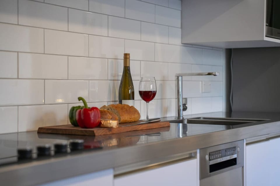 Stylish kitchen setup with fresh ingredients and wine, perfect for relaxing evenings and home-style dining