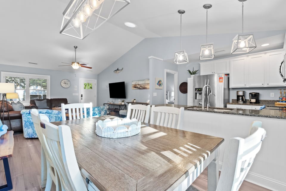 Bright dining space with seating for the whole group, seamlessly connected to the kitchen and living room for easy vacation gatherings and shared meals.