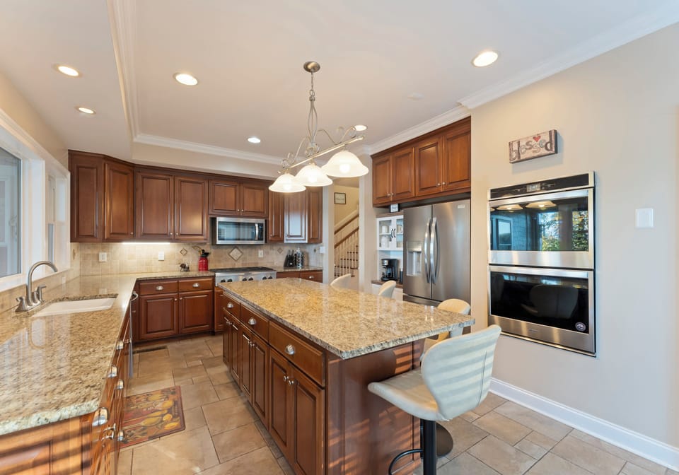 Wide kitchen view with stainless steel appliances and a large island.