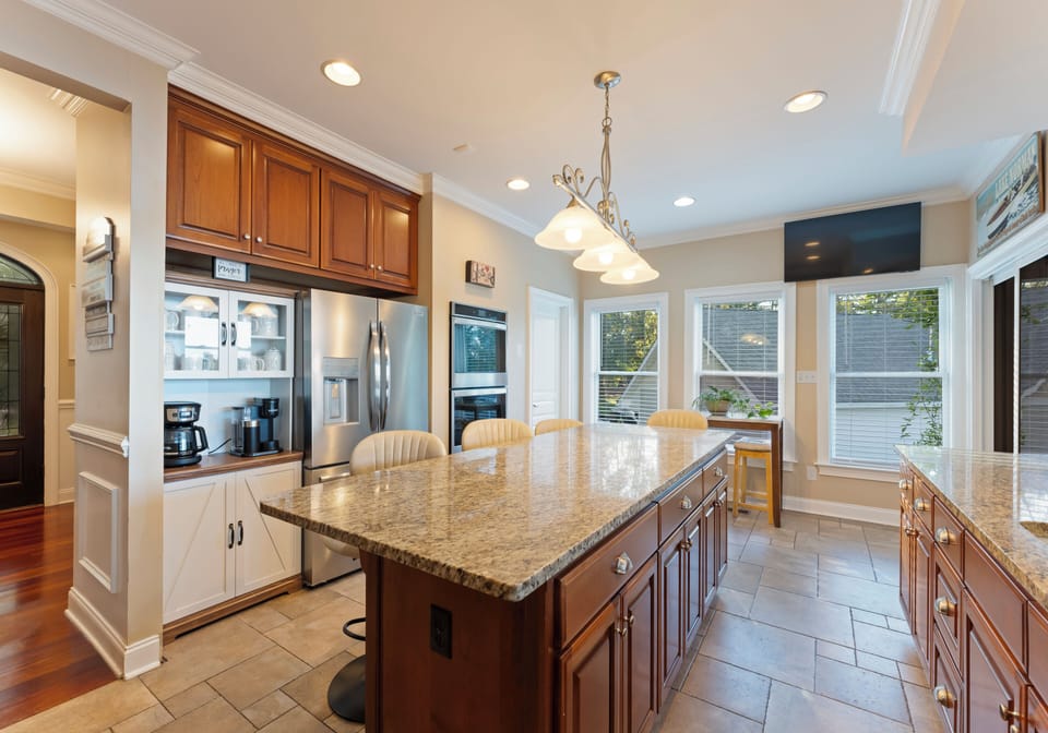 Kitchen island with countertop, TV, and pendant lighting.