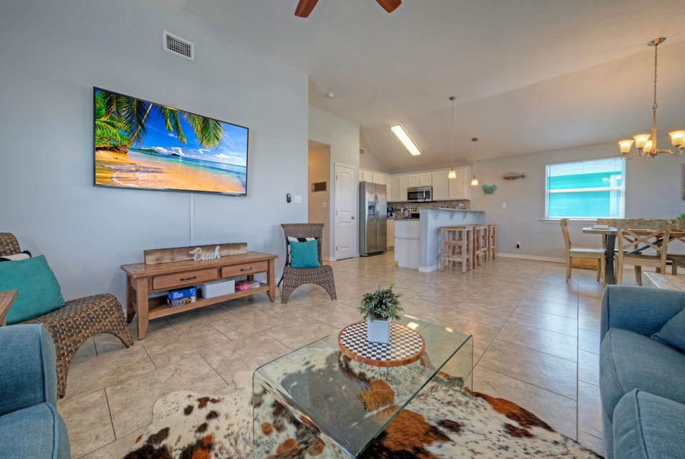 Open concept living area with comfy seating and a TV.
