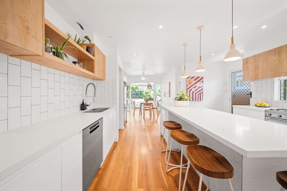 Prepare meals with ease in the modern kitchen featuring long stone benchtops, premium appliances and all the essentials for effortless home cooking.
