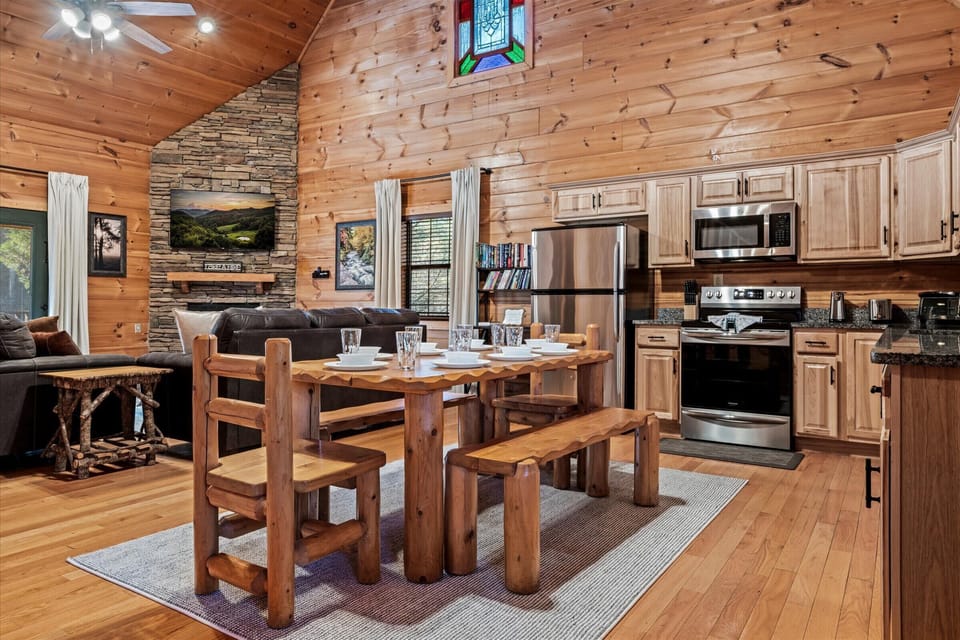 Enjoy a spacious kitchen with modern appliances, plenty of counter space, and a beautiful wooden dining table ideal for gathering.