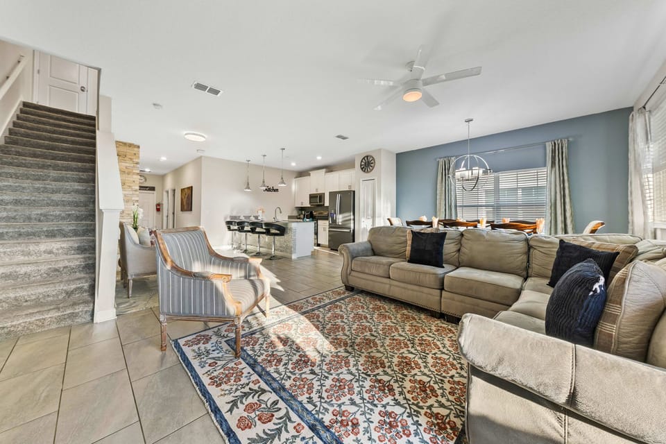 Bright open-concept living with a cozy sectional, stylish dining, and a sleek kitchen with breakfast bar - perfect for gathering and relaxing.