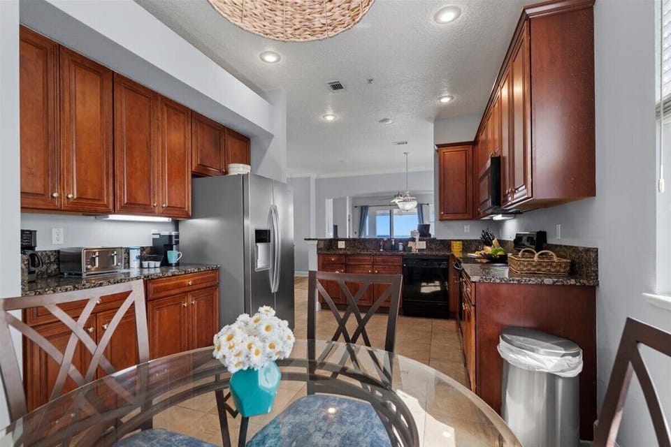 Fully equipped kitchen with warm wood cabinetry and a cozy dining nook.