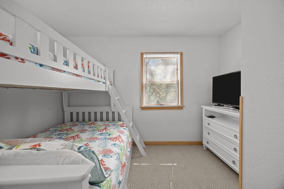 Mid Level Bunk Bedroom with twin-over-full bunk bed with a trundle, comfortably accommodating kids and adults alike
