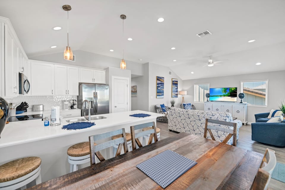 Gather around your spacious kitchen island for morning coffee or evening cocktails in this bright, open living space.