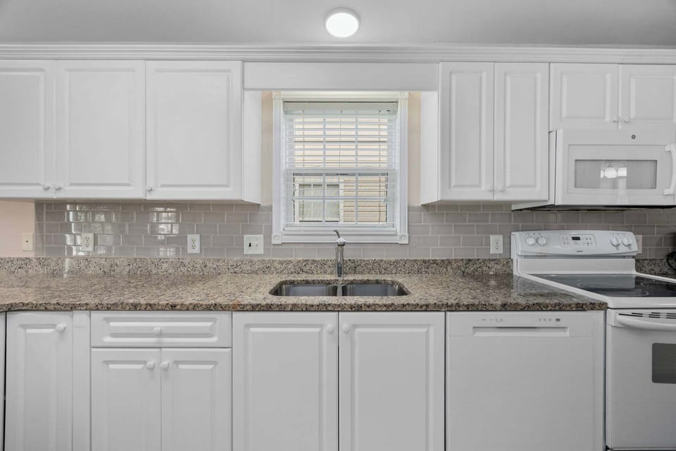 Updated and Modern Granite and Subway Tile