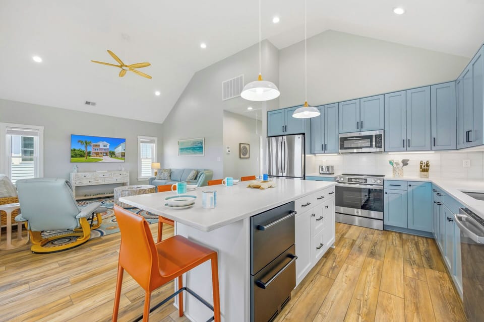Gather around this bright, fully equipped kitchen island where vacation meals become cherished memories—complete with modern appliances and open-concept flow into the living area.
