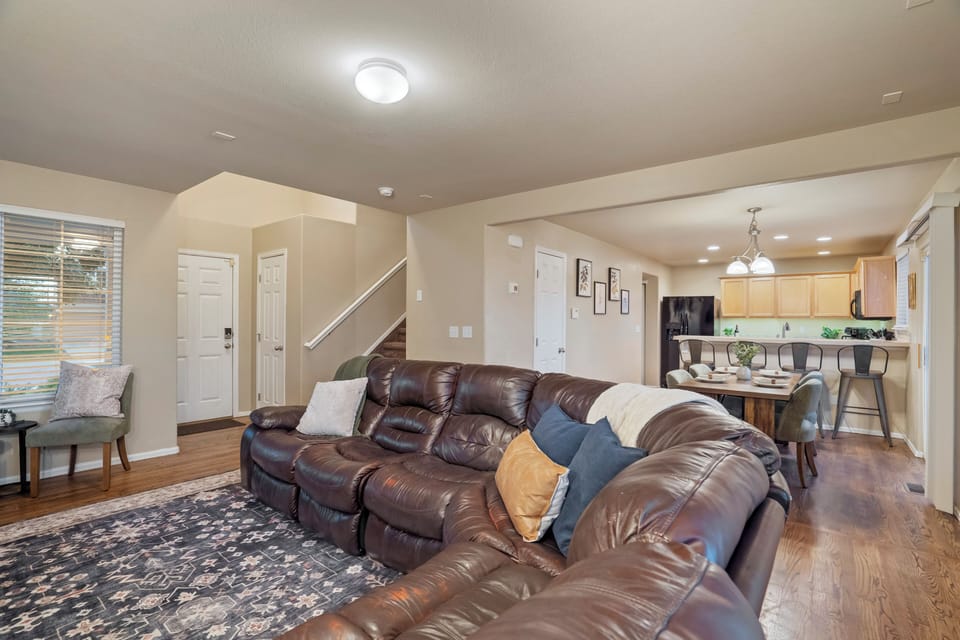 Cozy up in this inviting space with a soft sectional, warm lighting, and smart TV.
