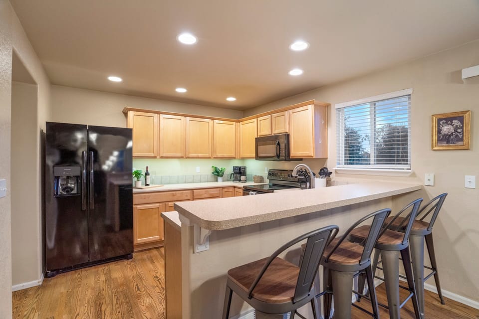 Sleek counters, spacious layout, and a breakfast bar make this kitchen both beautiful and functional.