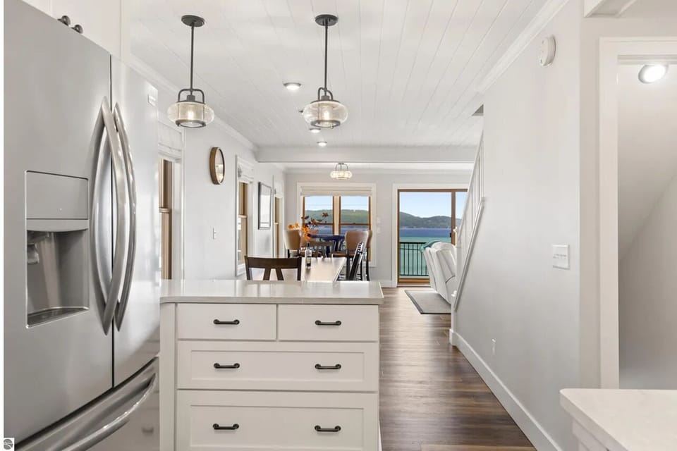 KITCHEN (MAIN FLOOR):  The home has a beautiful modern kitchen with all appliances (including a dishwasher) and a good supply of cooking and dining utensils