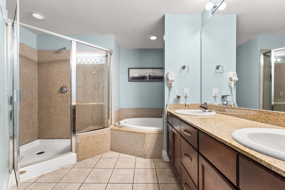 Spacious bathroom with separate shower and soaking tub in a modern setting