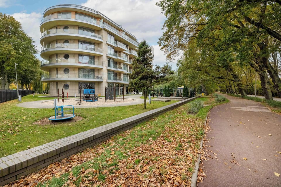 The studio is located in a modern residential building surrounded by greenery, ensuring a quiet and pleasant environment.