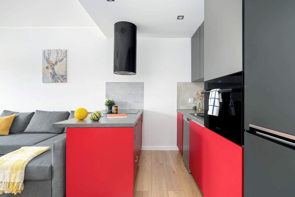 The sleek design of the kitchenette blending seamlessly with the living area.