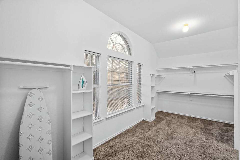 Cozy study room with built-in shelves and a large window that fills the room with natural light. Ideal for remote work, studying, or reading during your stay. Perfect for mid-term stays near Fort Worth, offering both comfort and functionality.