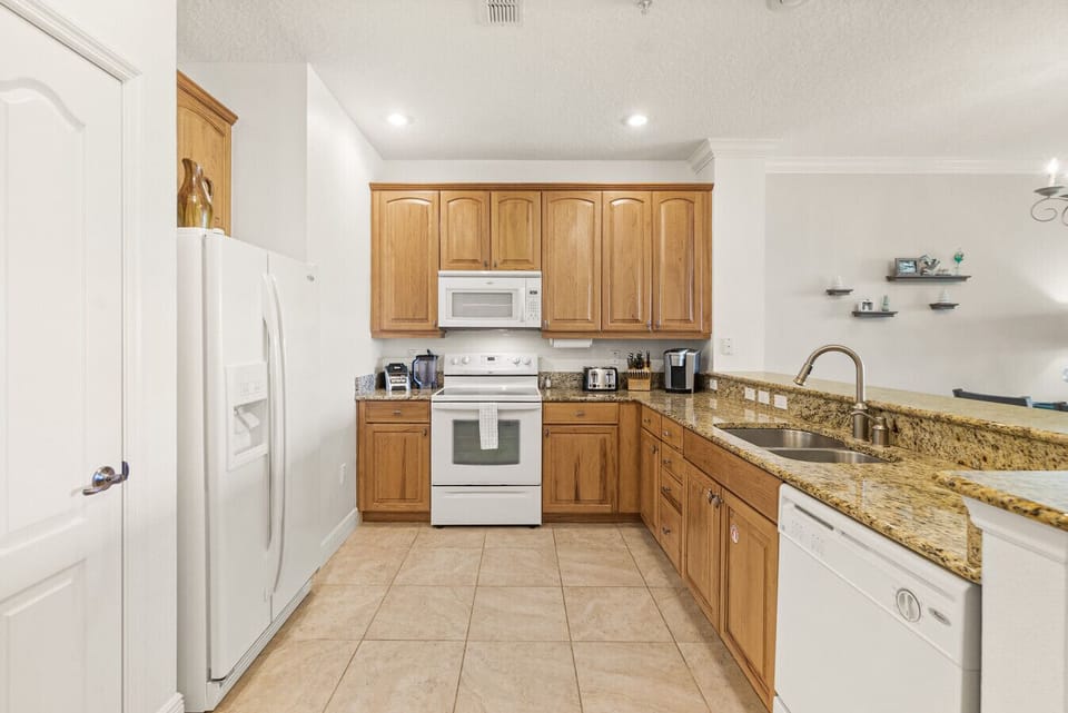 Fully stocked kitchen with granite countertops, full-size appliances, and everything needed for extended stays.