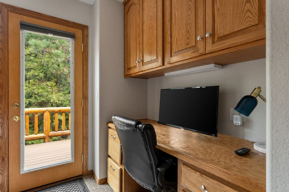 Your dedicated workspace features ample light, a desk chair, and a smart TV