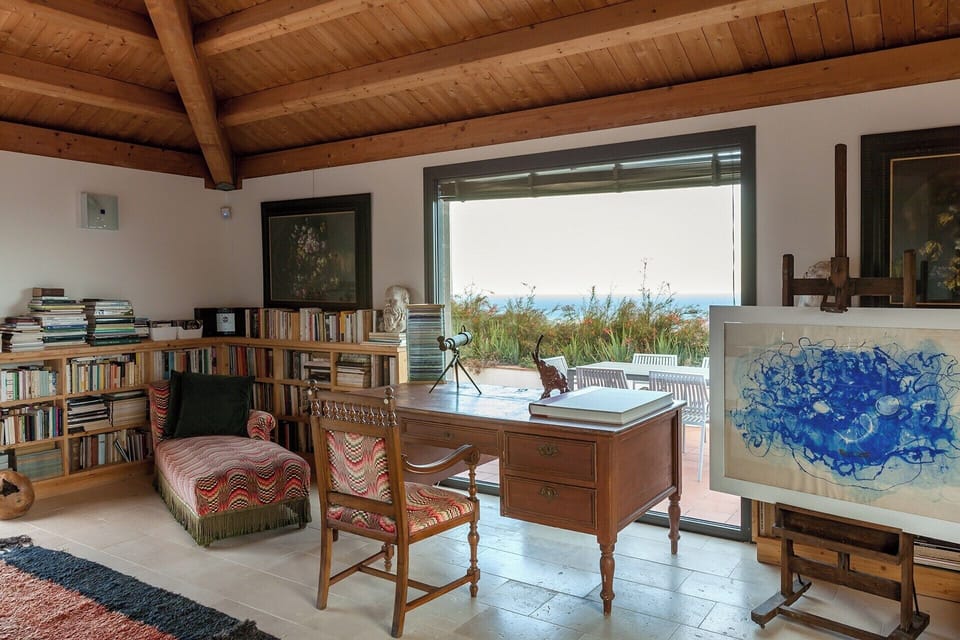 The top-floor sitting area is surrounded by a wrap-around terrace.