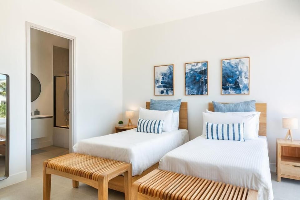Settle into twin comfort with crisp linens and calm coastal art.