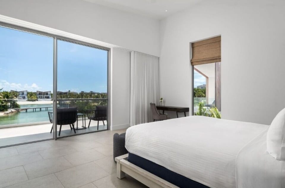 Wake to waterfront views from your airy king bedroom.