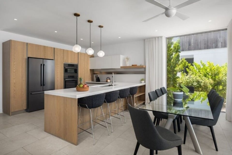 Gather for sunset dinners around the sleek, modern dining table.