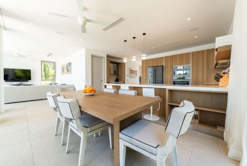 Gather for long dinners beside the sleek chef’s kitchen.