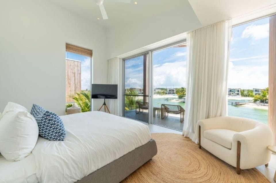 Wake to sunlit waterfront views from a cloud-soft bed.