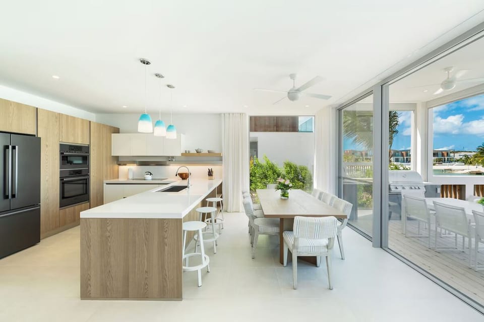 Gather for lively meals in this sunlit, designer kitchen.