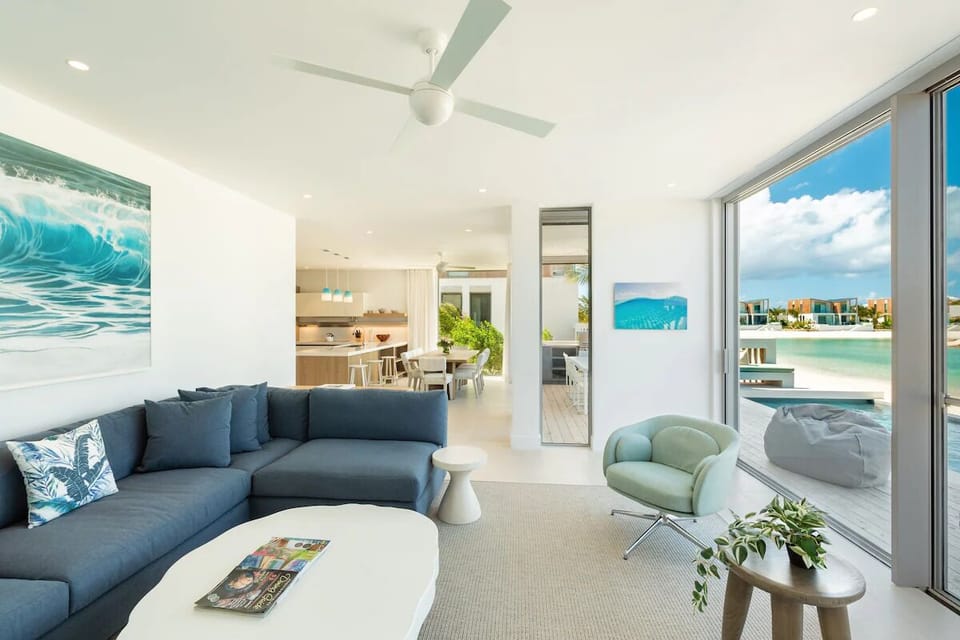 Gather in the airy living room with sweeping water views