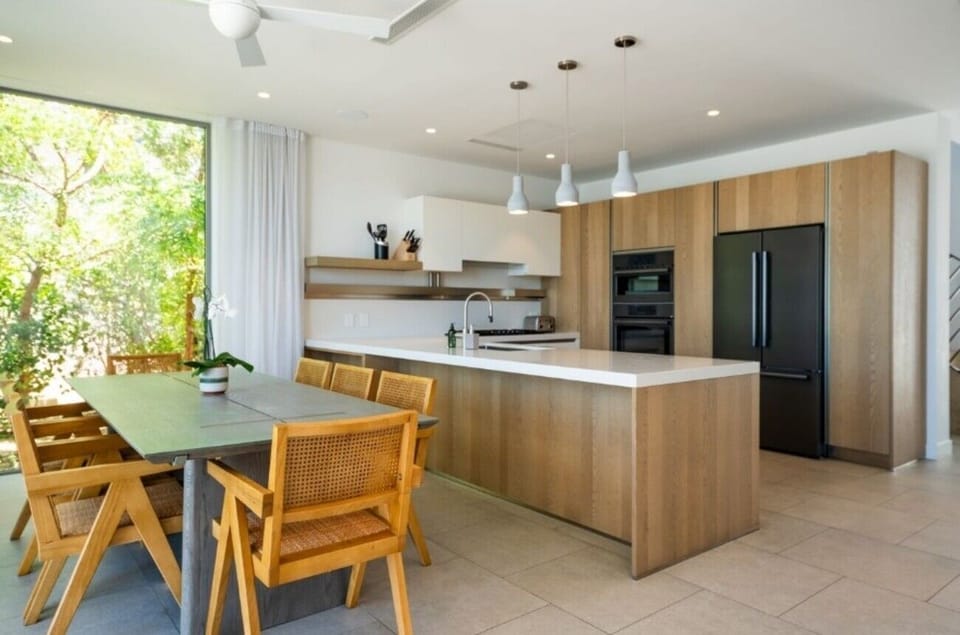 Cook together with spacious counters, modern lighting, and airy flow.