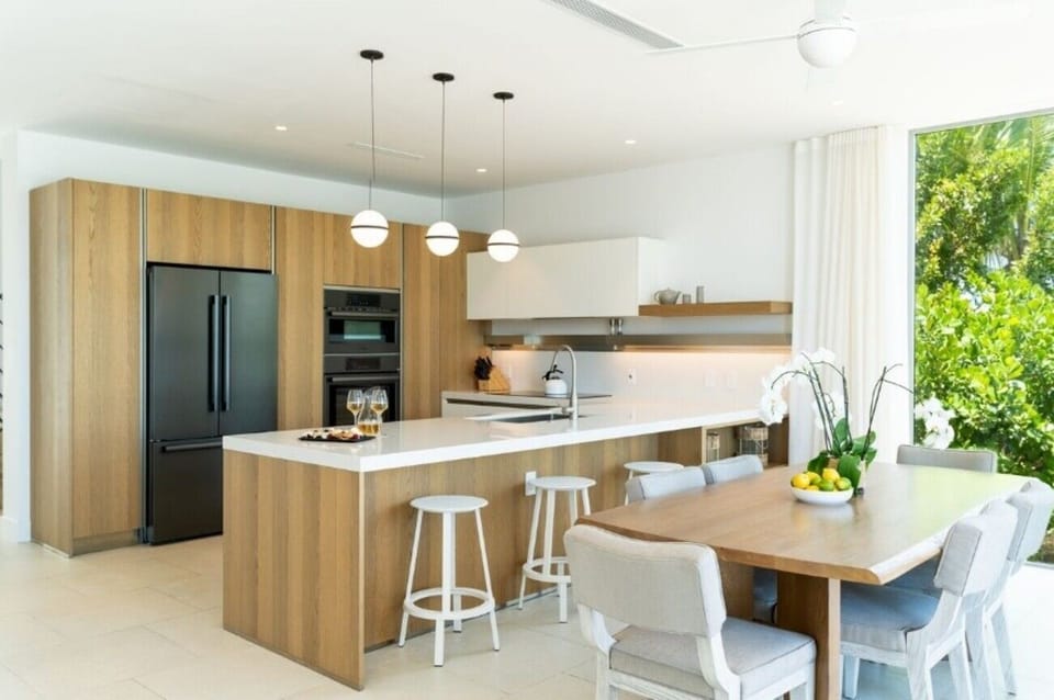 Cook together in a bright chef’s kitchen beside dining.