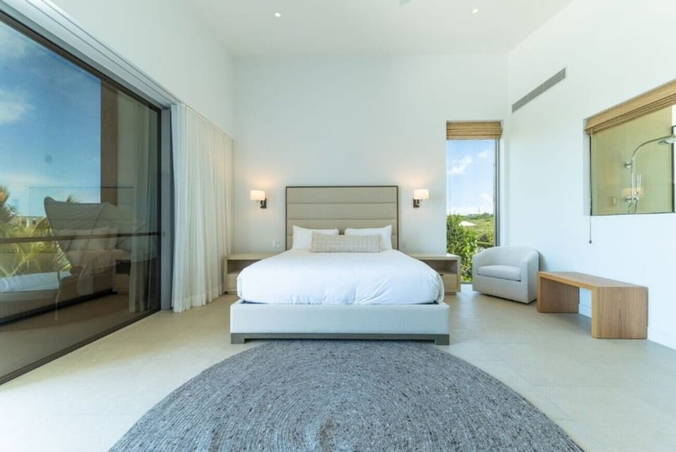 Unwind in crisp linens within airy, sunlit serenity.