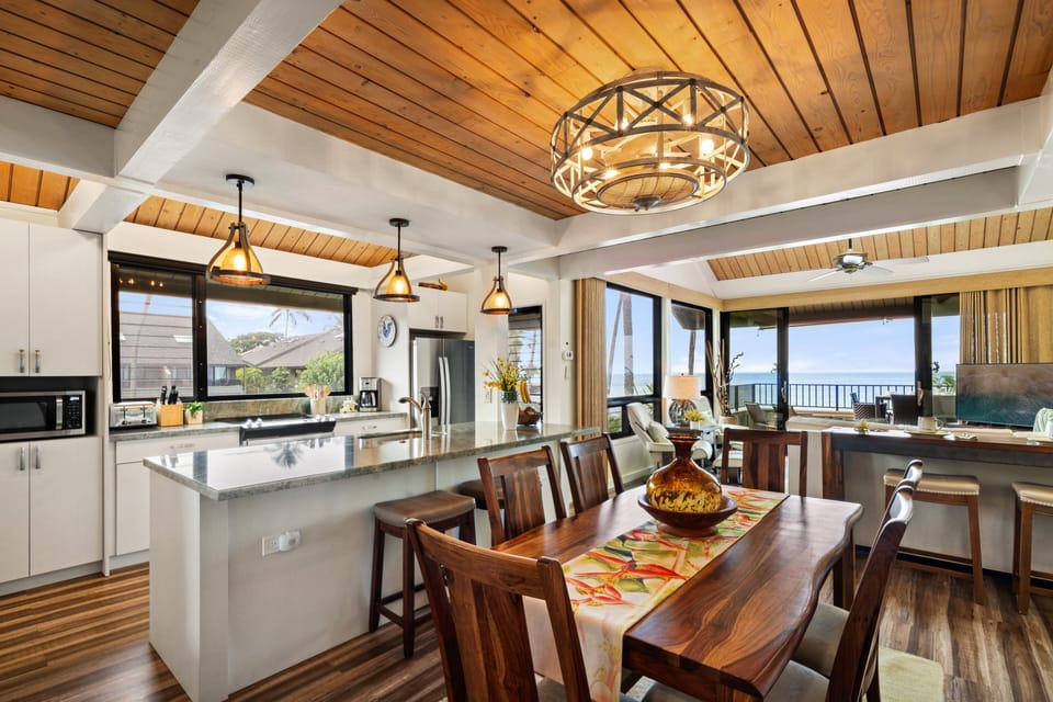 Cook and dine in style with a modern kitchen and elegant dining space framed by natural light and coastal charm.