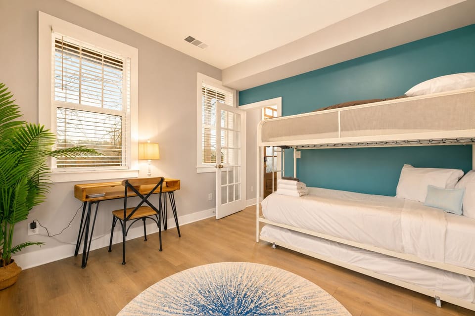A versatile bunk room with workspace for rest, play, or productivity