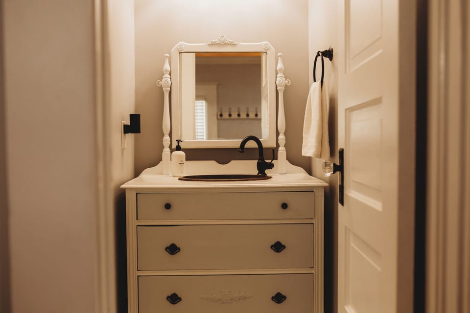 Experience the Craftsman Charm in every detail! This unique, antique vanity-style sink adds a touch of bespoke elegance to the powder room. A stylish and functional amenity for your Elegant Retreat in DTWN. 🔑