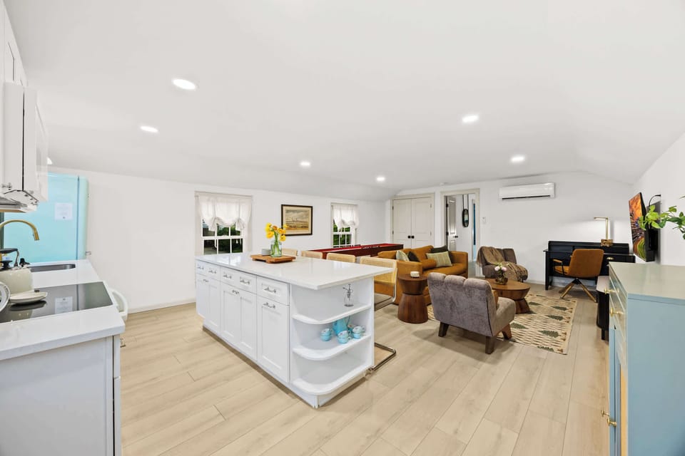 Living Room: Relax and unwind in this spacious open-concept living area, perfect for games and gathering.