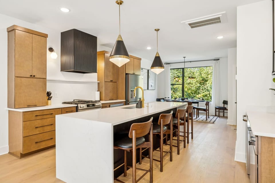 Kitchen: Sleek lines, warm tones, and high-end touches — the perfect kitchen for cooking, entertaining, and enjoying life together.