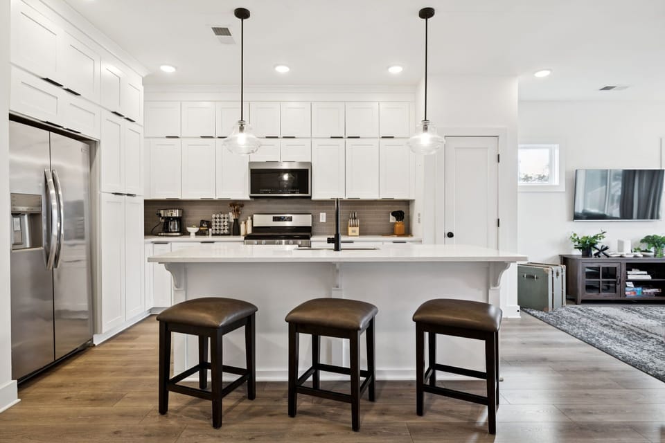 Kitchen: Sun-filled and social! The kitchen flows seamlessly into the living space, creating a welcoming atmosphere for gatherings.