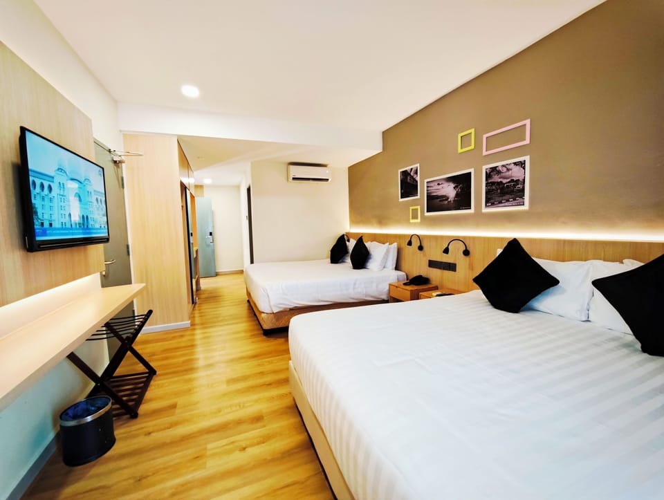Deluxe Quadruple Room, Balcony, Garden View | In-room safe, desk, laptop workspace, blackout drapes