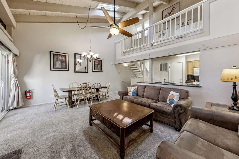 Relax in this spacious loft-style living area with soaring ceilings, cozy seating, and an open layout perfect for gathering.