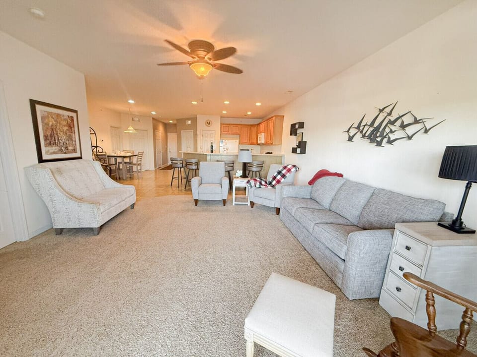 Spacious open-concept living room with comfortable seating, large gathering space, and direct flow to kitchen and dining—perfect for relaxing Lake of the Ozarks group getaways.