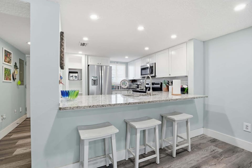 Enjoy casual dining at the kitchen island, seating for three guests.