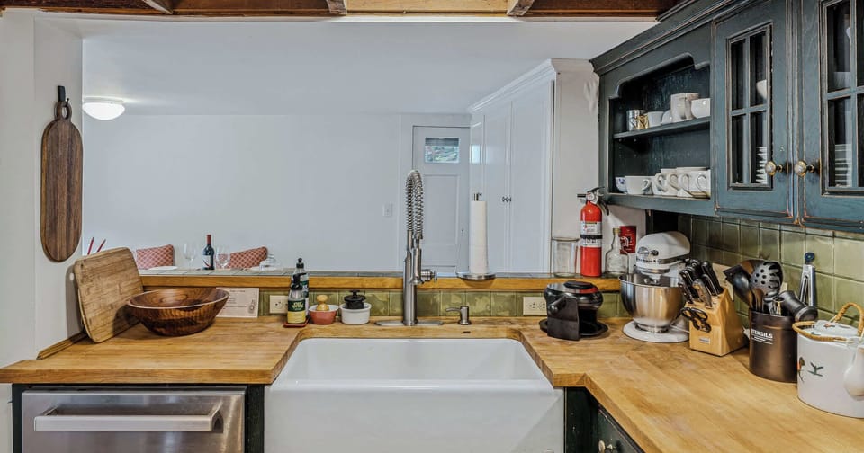 Dining area with seating for six under a pendant light and exposed beams