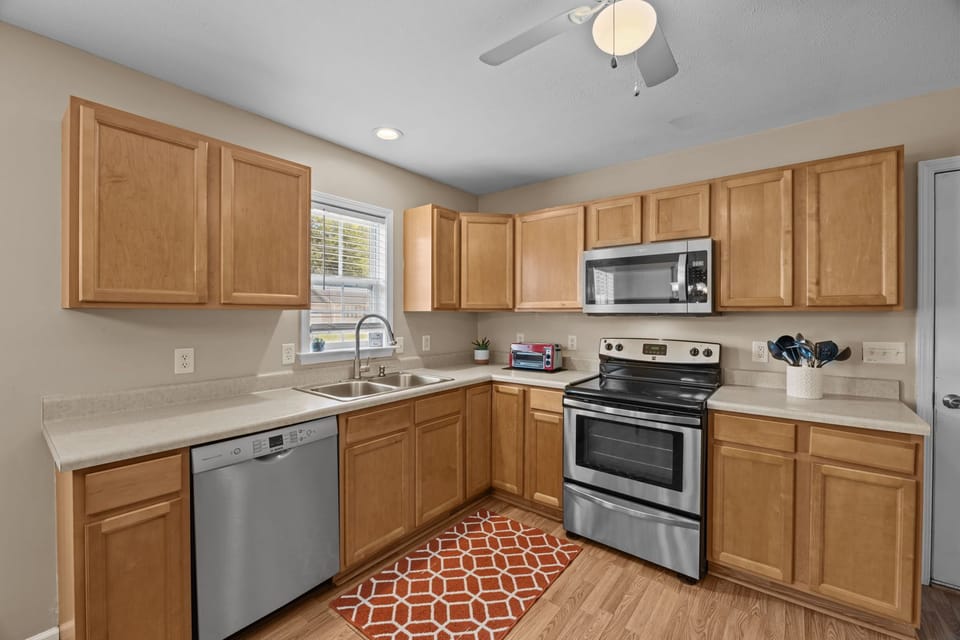 Fully equipped kitchen stocked with cooking utensils and a dishwasher.