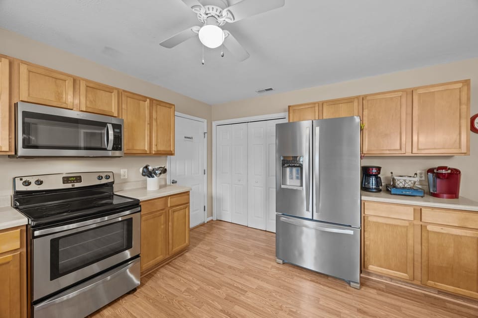 The refrigerator dispenses filtered water and ice. Electric stove and microwave.