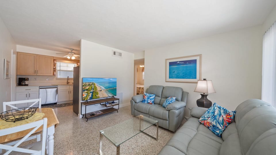 Bright living area with Smart TV for streaming after a day at the beach.